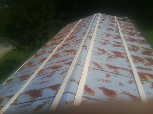 Rusted metal roof panels with new wood purlins before replacement — Storm Damage Roof Repair in Flourtown by Roofing Brothers